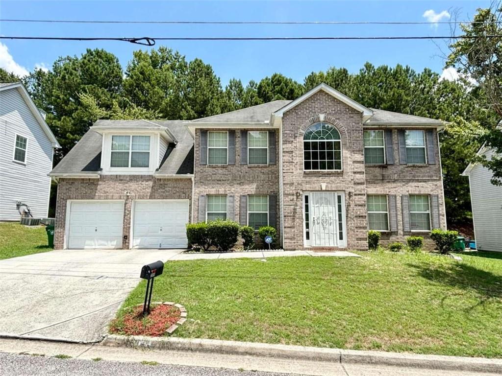 a front view of a house with a yard