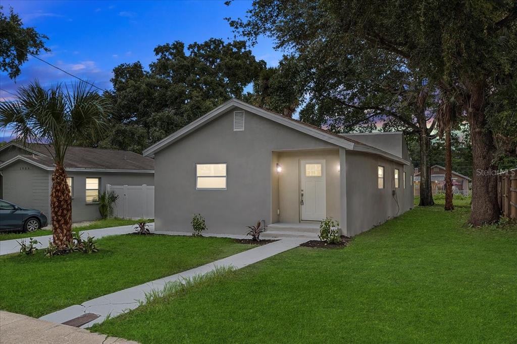 a front view of house with yard and green space