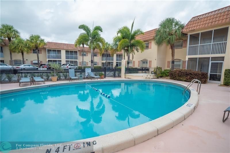 a view of a swimming pool with a patio