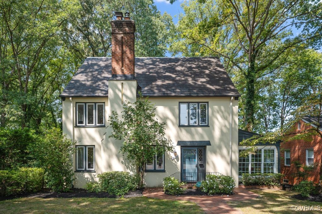 a front view of a house with a garden