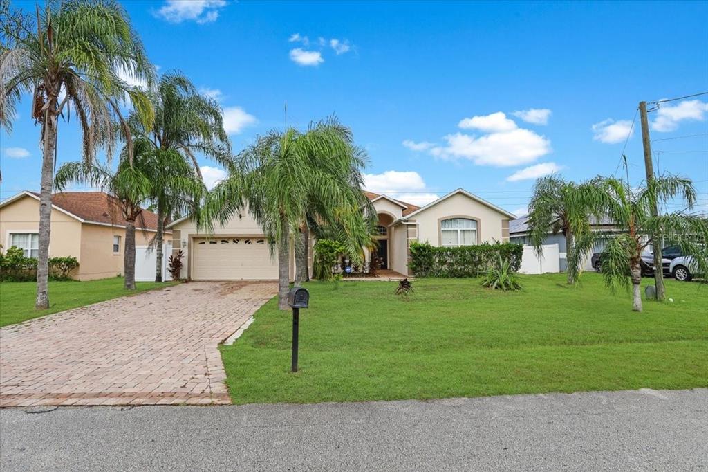 a front view of a house with a yard and garage