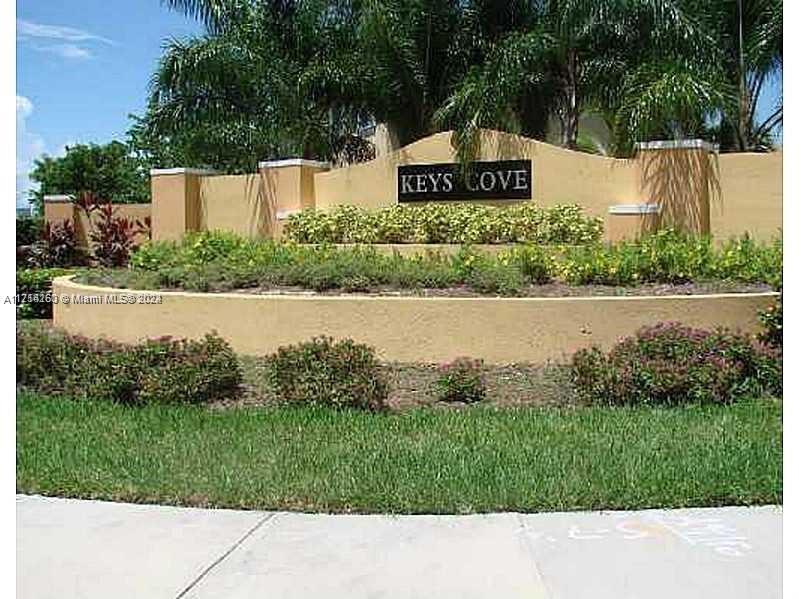 a picture of a park with a plants and trees in the background