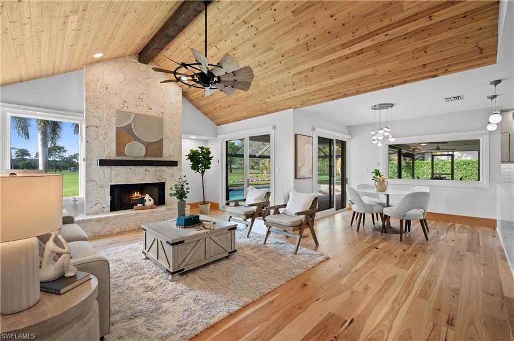 a living room with furniture a fireplace and a table