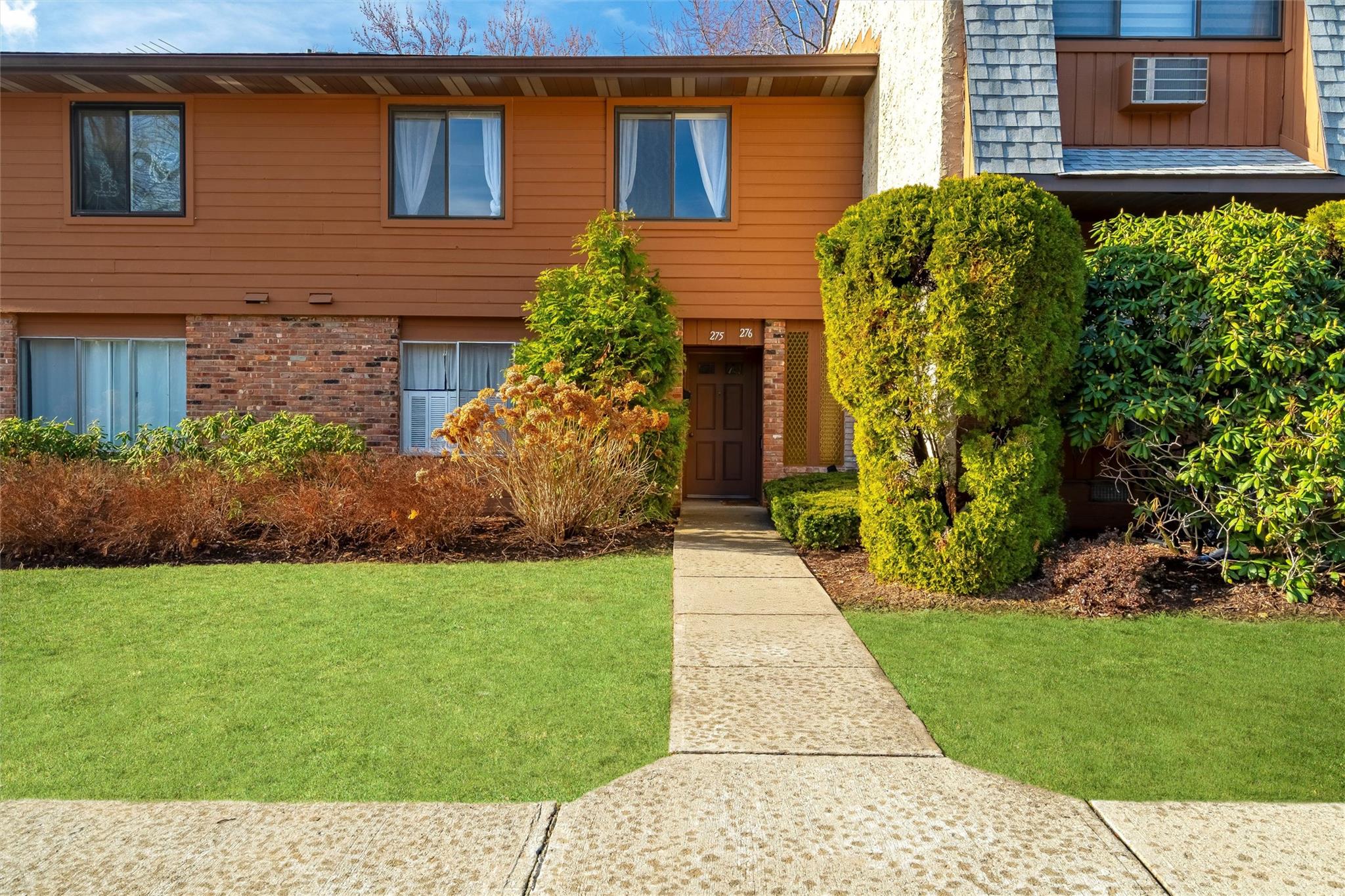 a front view of a house with a yard