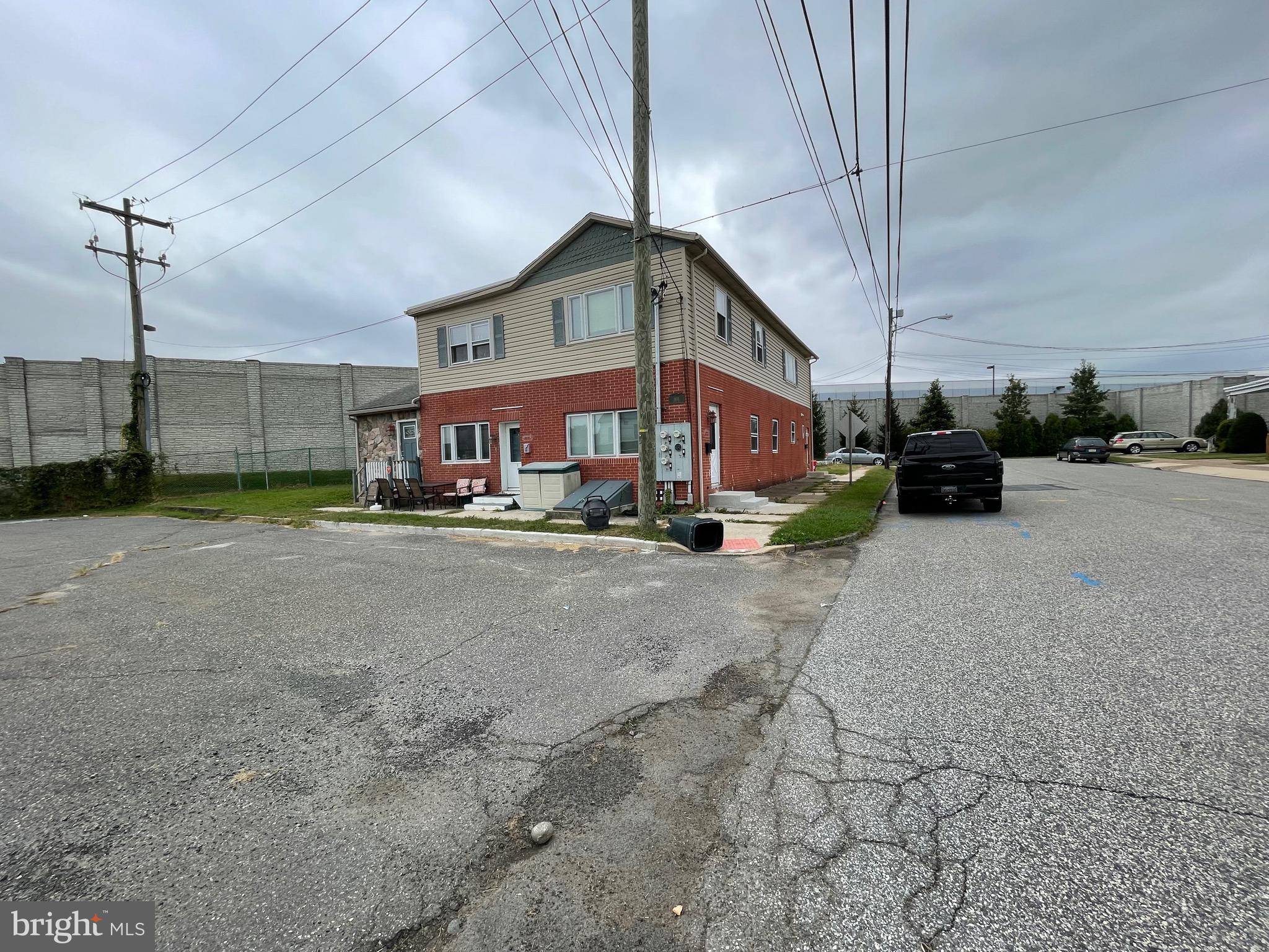 a street view with a car park in front of it