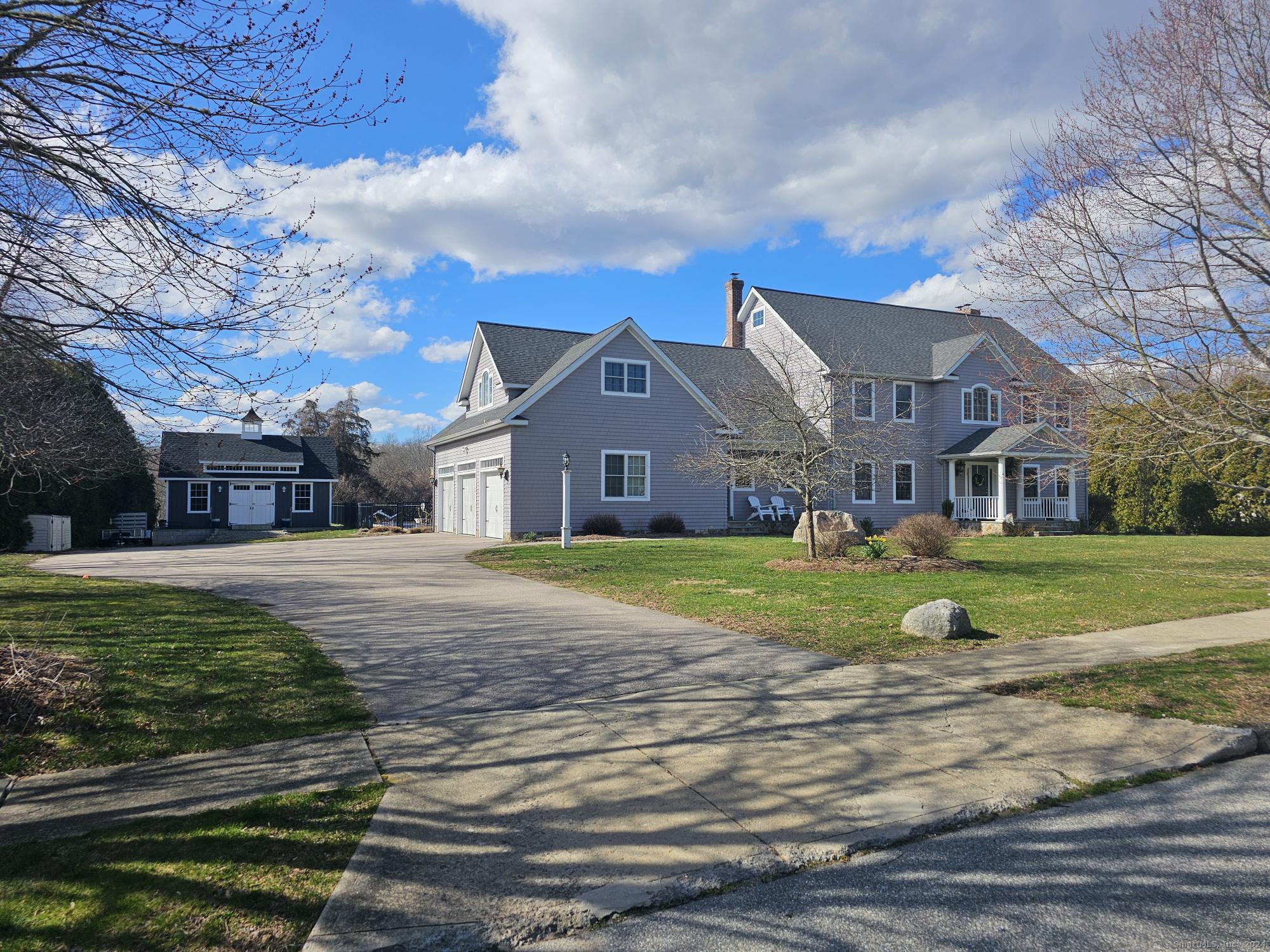 a front view of house with yard and green space