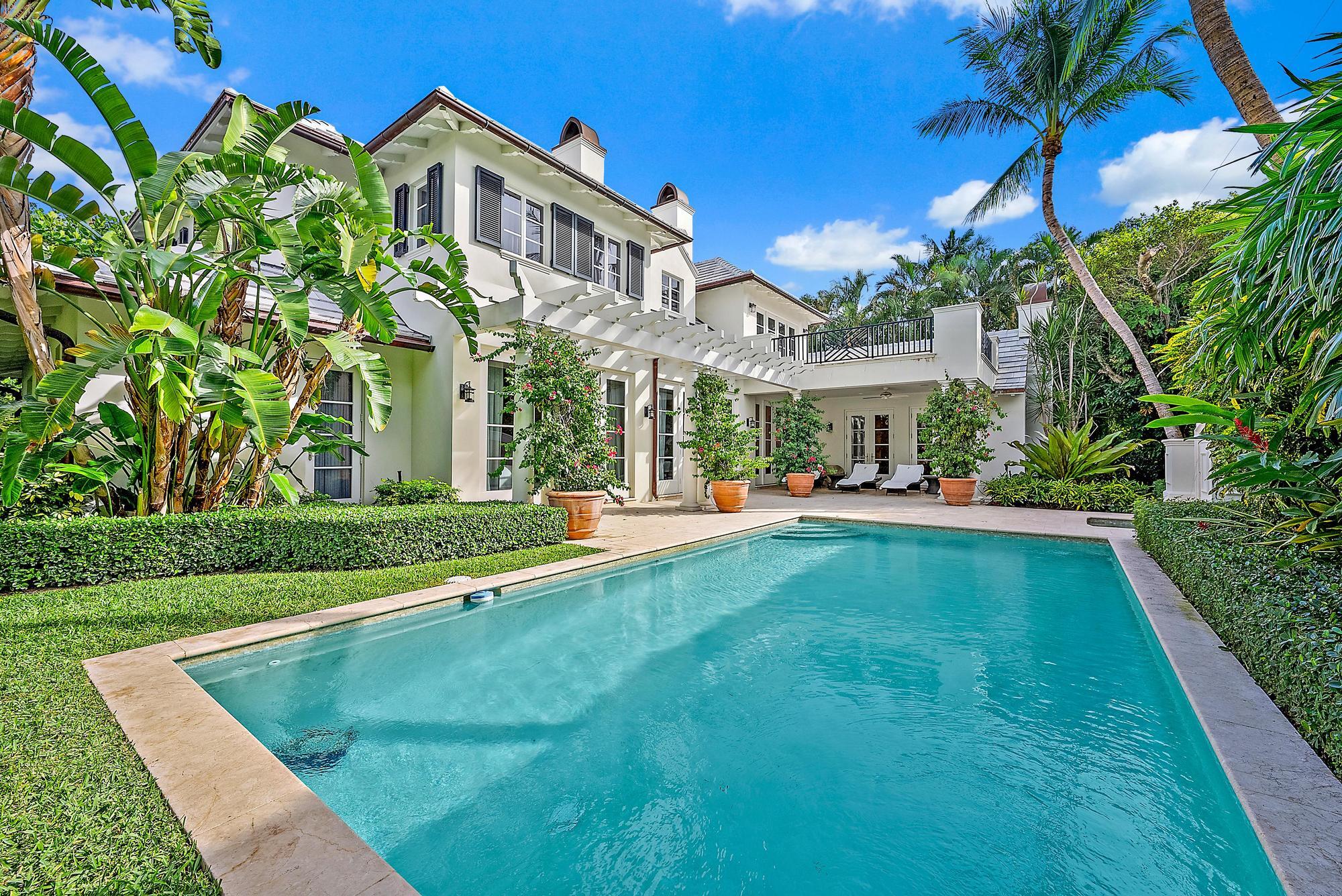 a view of an house with backyard space and balcony