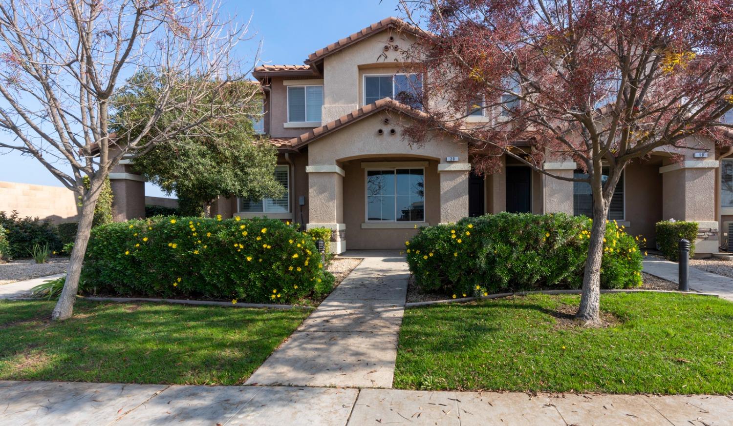 a front view of a house with a garden