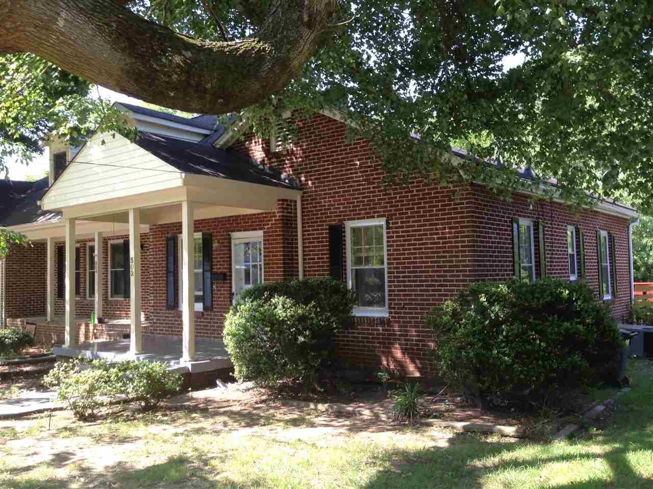 a view of a house with a yard and plants