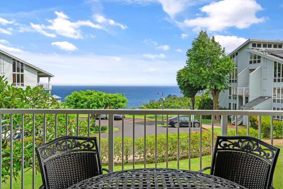 a view of a chairs and table in the balcony