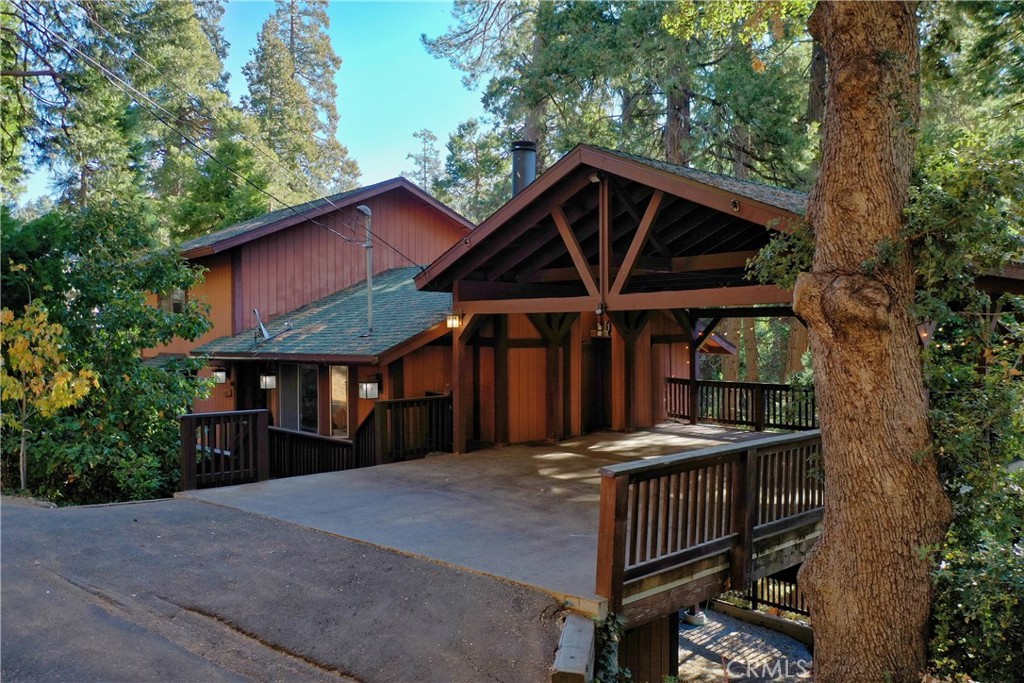 a front view of a house with yard and trees