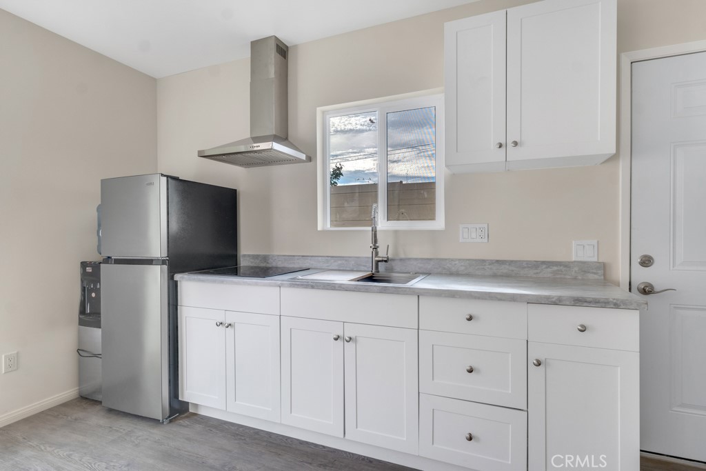 a kitchen with granite countertop a sink stainless steel appliances and cabinets