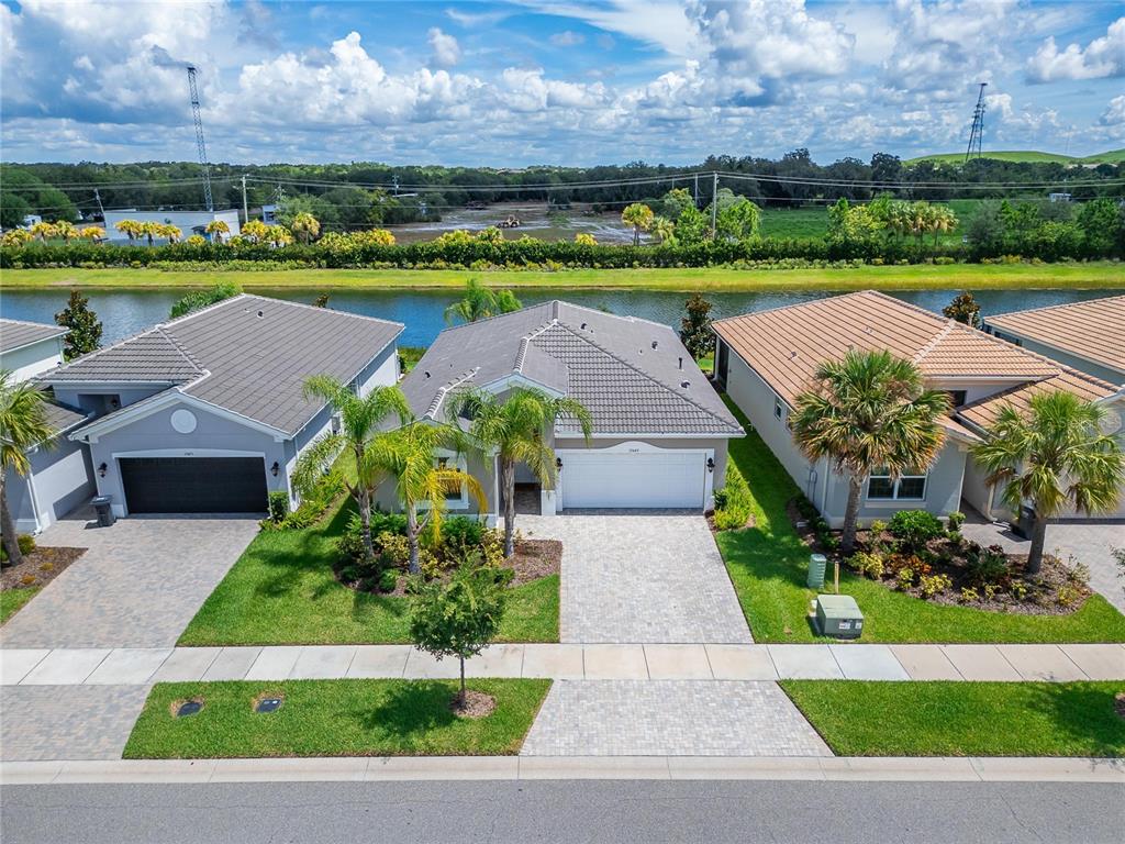 an aerial view of a house with a garden and lake view