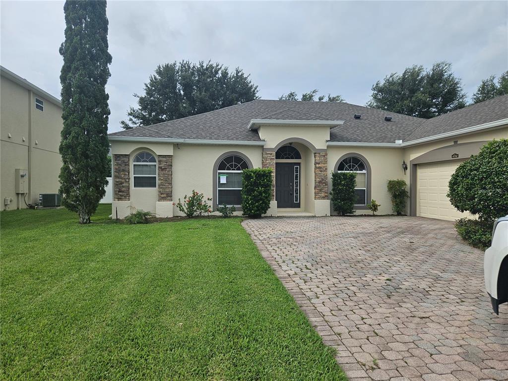 a front view of a house with a garden