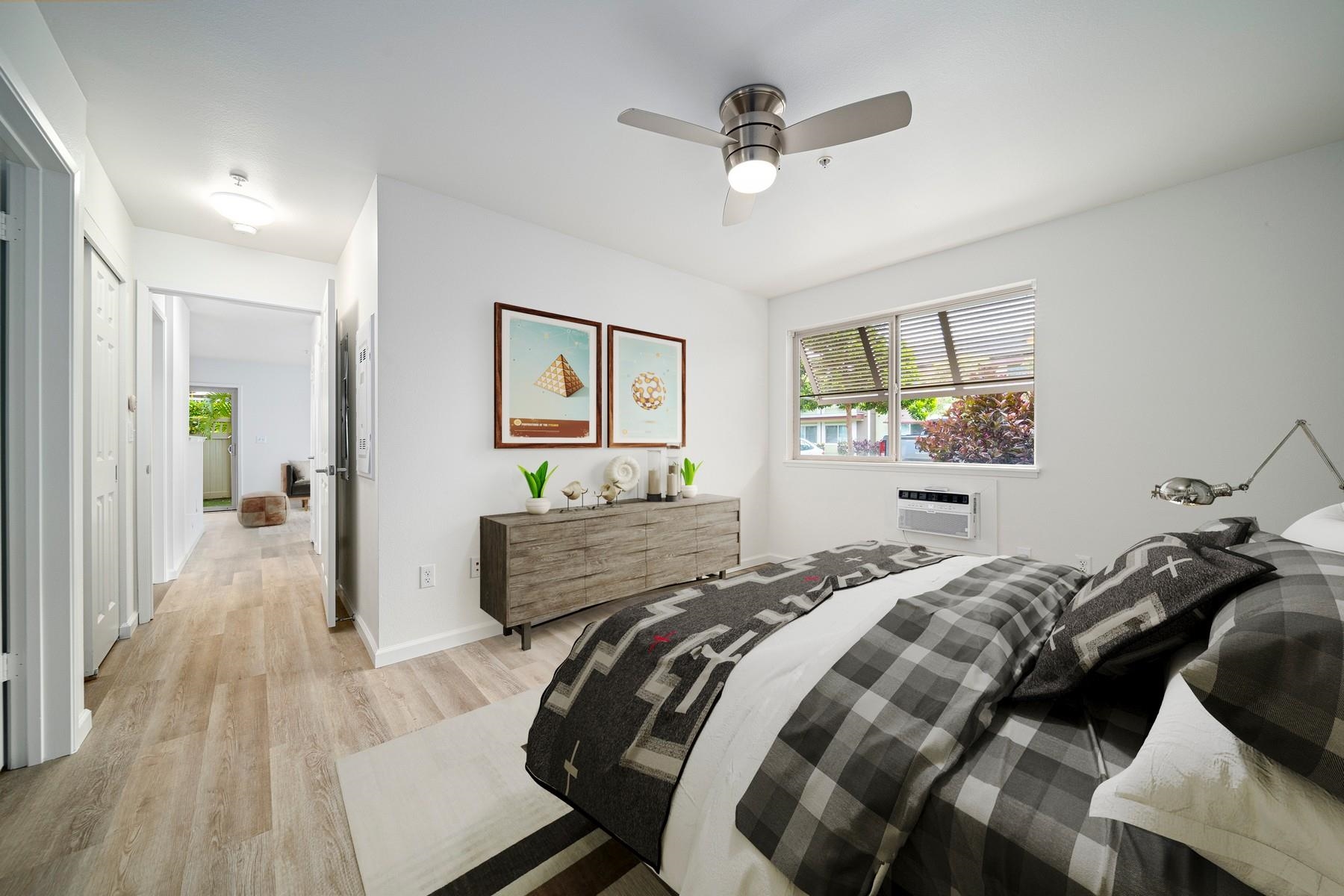 a bedroom with bed and a large mirror