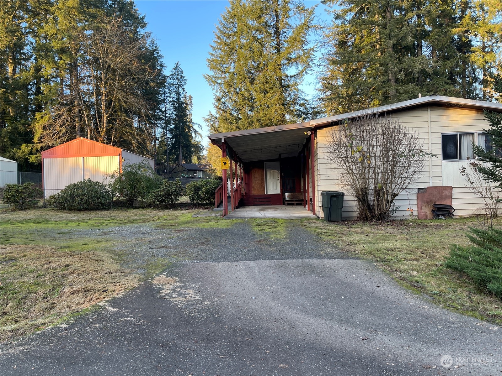 a front view of house with yard and trees in the background