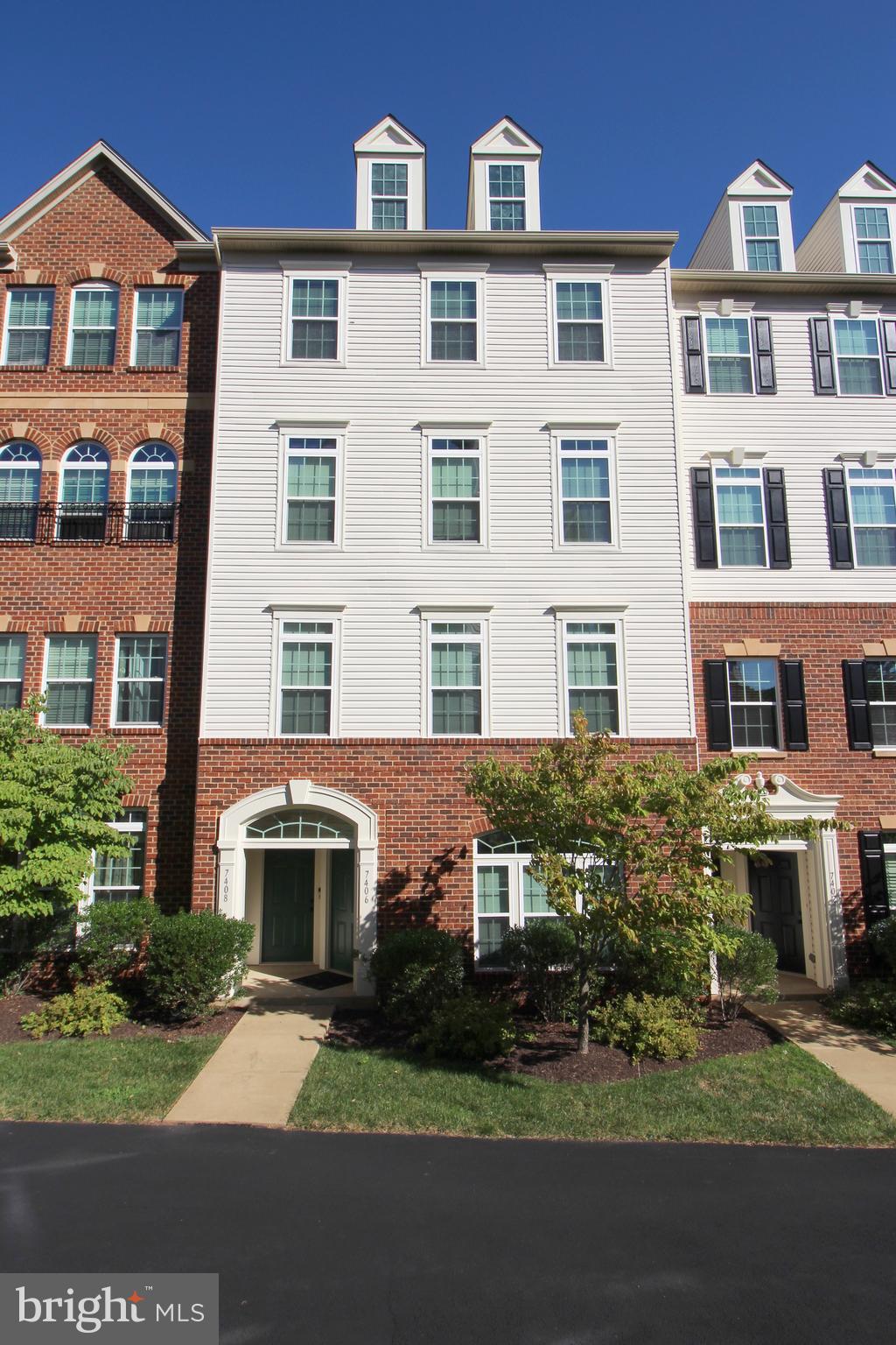 a front view of residential houses with yard