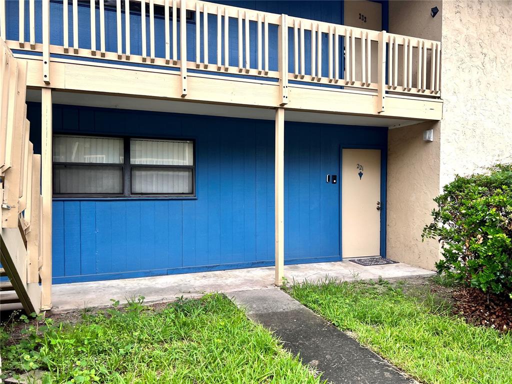 a view of a house with a small deck