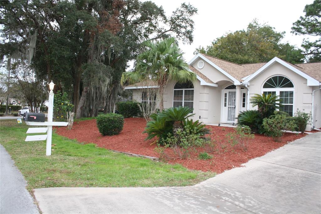 a front view of a house with a garden