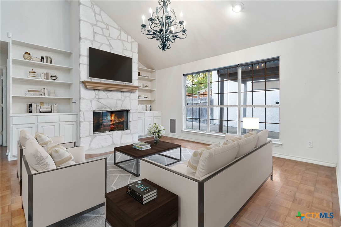 a living room with furniture a fireplace and a flat screen tv