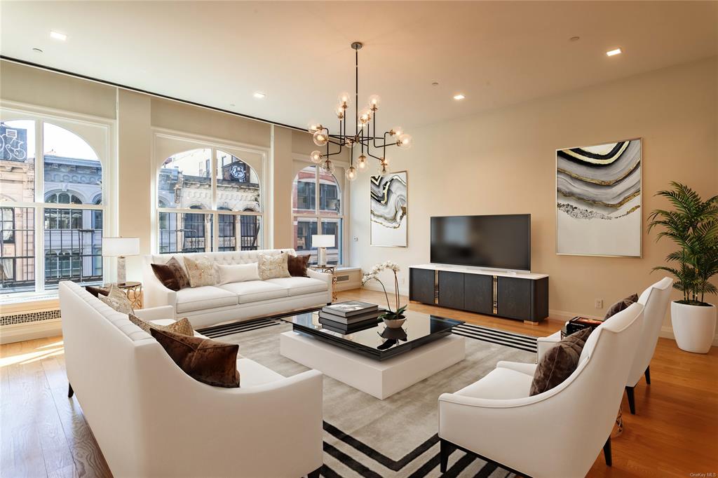 Living room featuring light hardwood / wood-style flooring and a chandelier