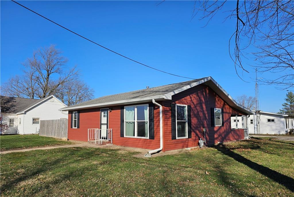 a view of a house with a yard and sitting area