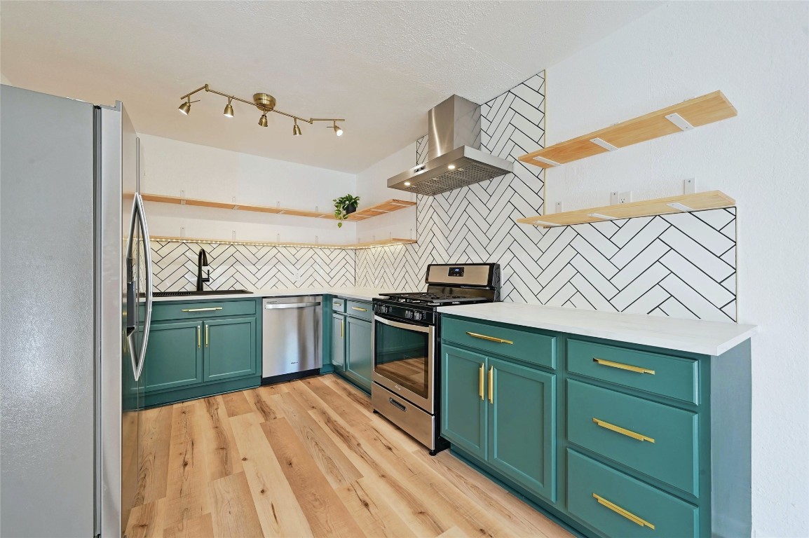 a kitchen with a sink a microwave and cabinets