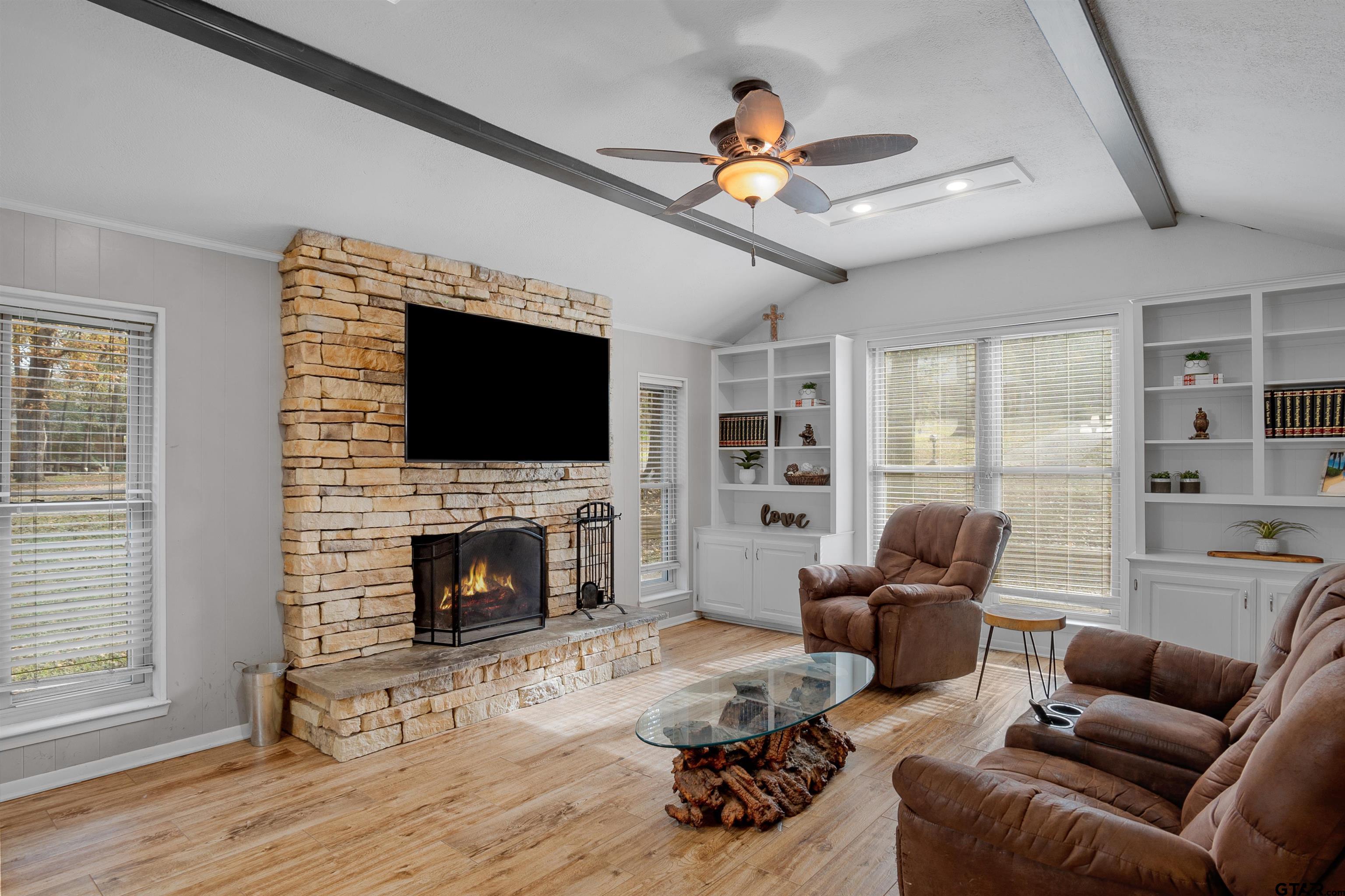 a living room with furniture flat screen tv and a fireplace