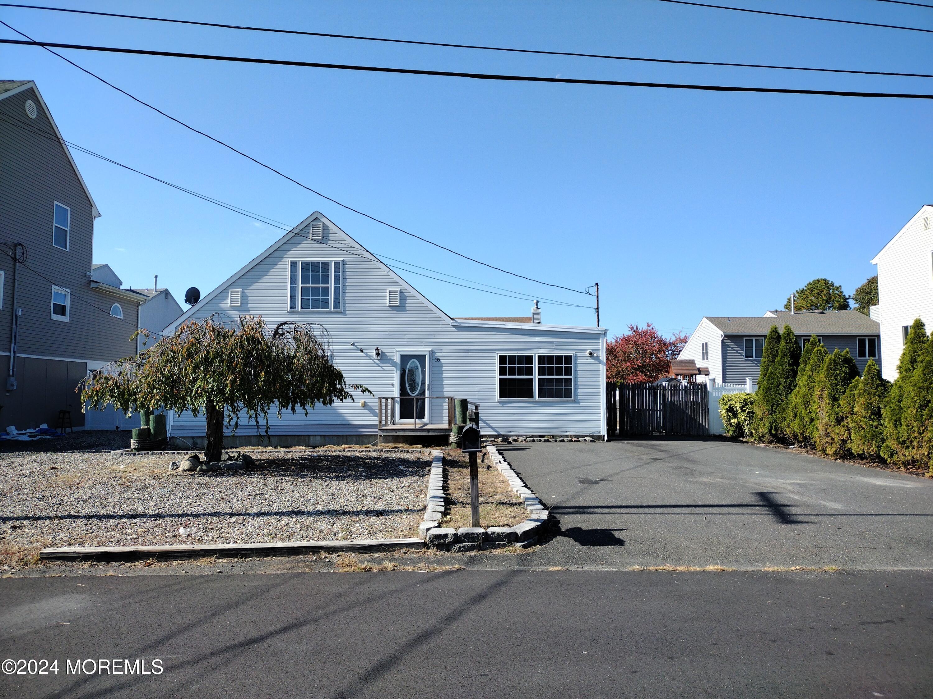 a front view of a house with a garden and plants