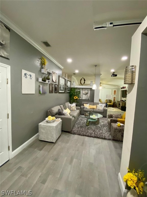 a living room with furniture and kitchen view