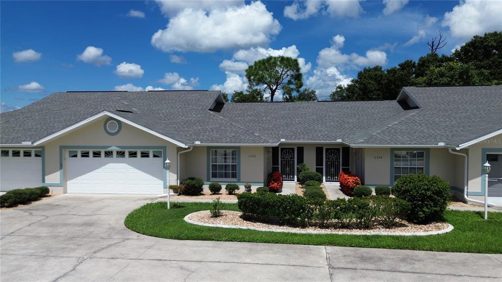 a front view of house with a yard and potted plants