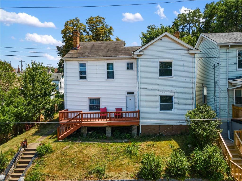 a aerial view of a house with swimming pool next to a yard