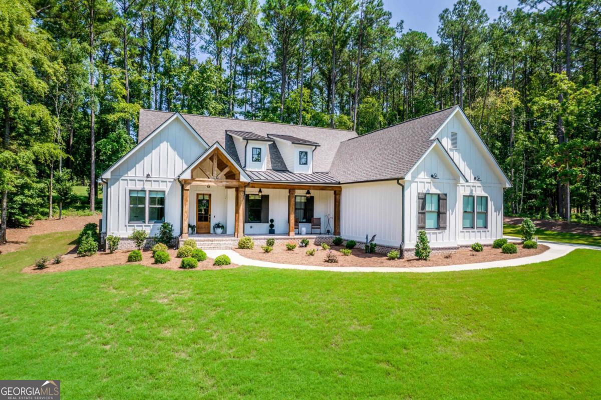 a front view of a house with patio and garden