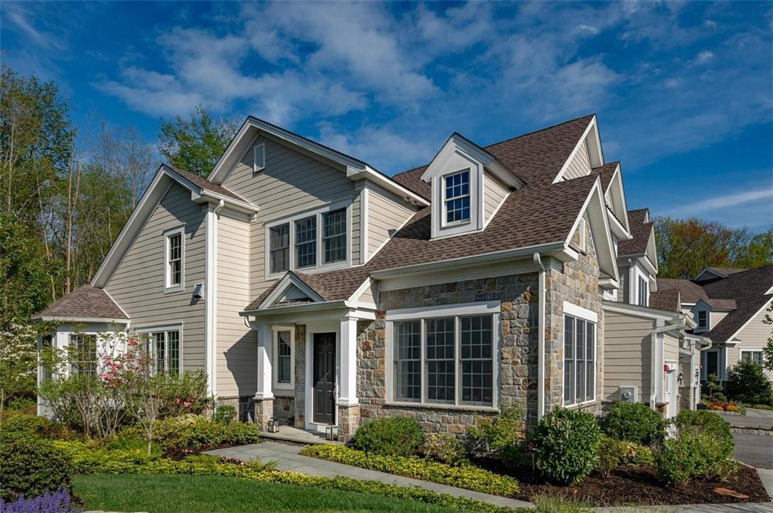 Architectural masterpiece! Stone and Hardi board siding with bluestone walkway.