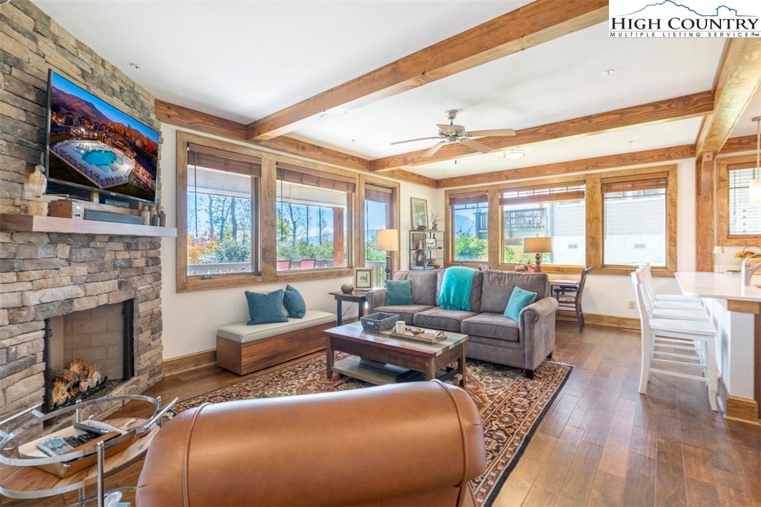 a living room with furniture fireplace and flat screen tv