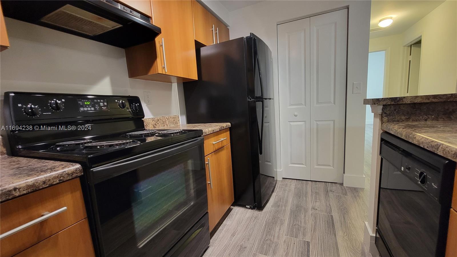 a kitchen with a stove and a refrigerator