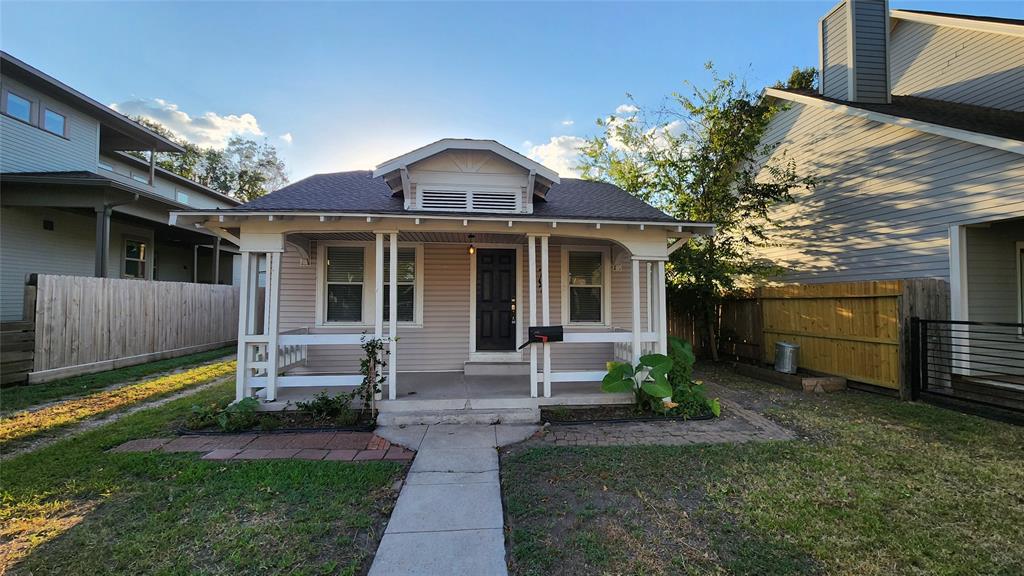 a front view of a house with a yard and outdoor seating