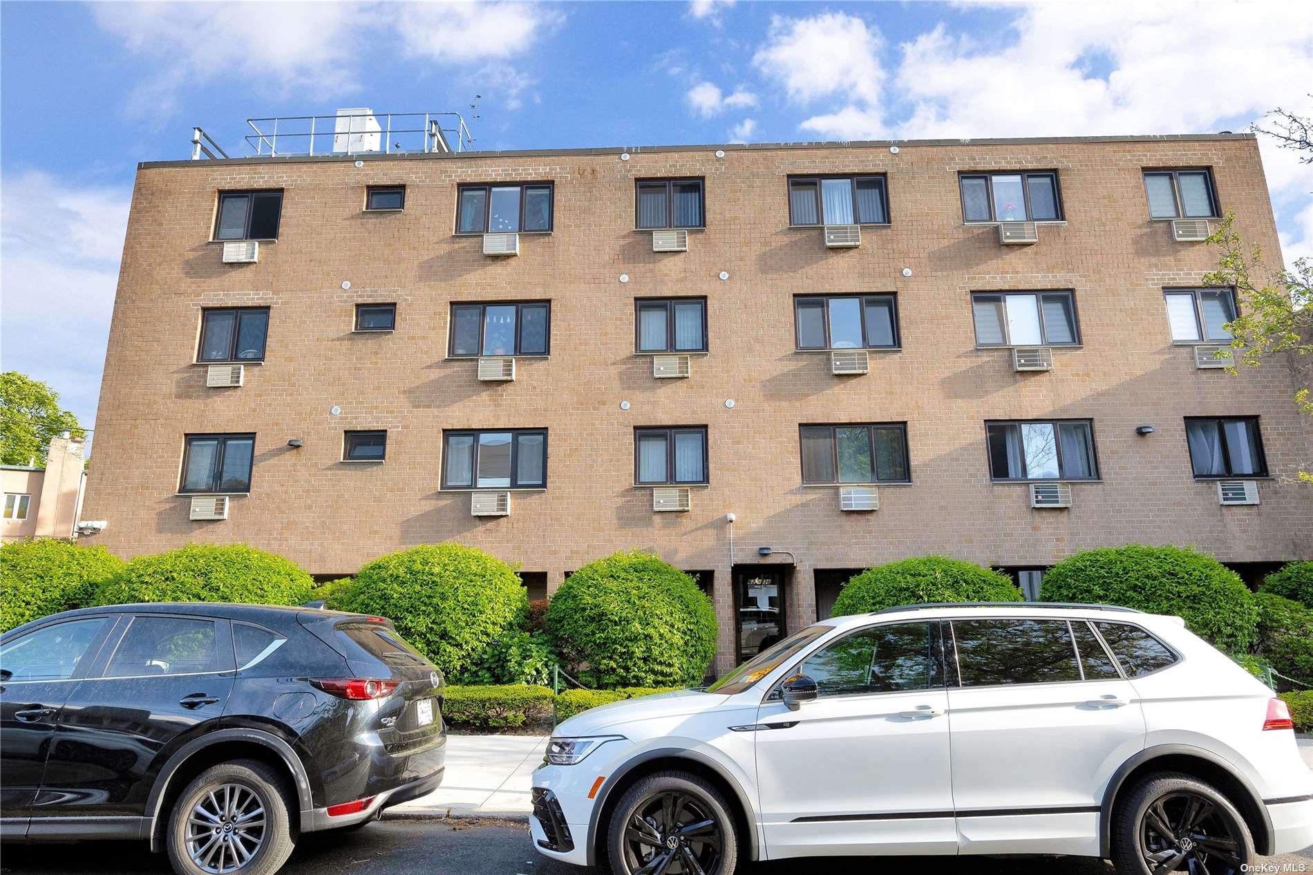 a front view of a house with parking space