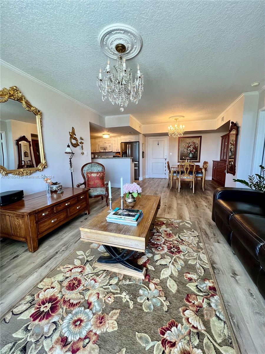 a living room with furniture and a chandelier