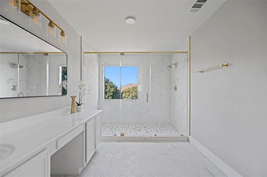 a bathroom with a tub sink and mirror