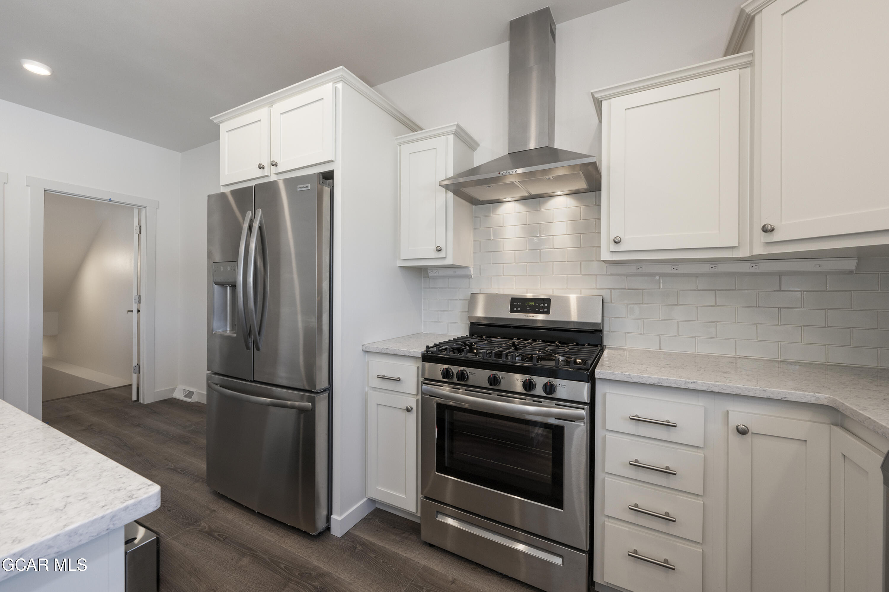 a kitchen with cabinets and stainless steel appliances