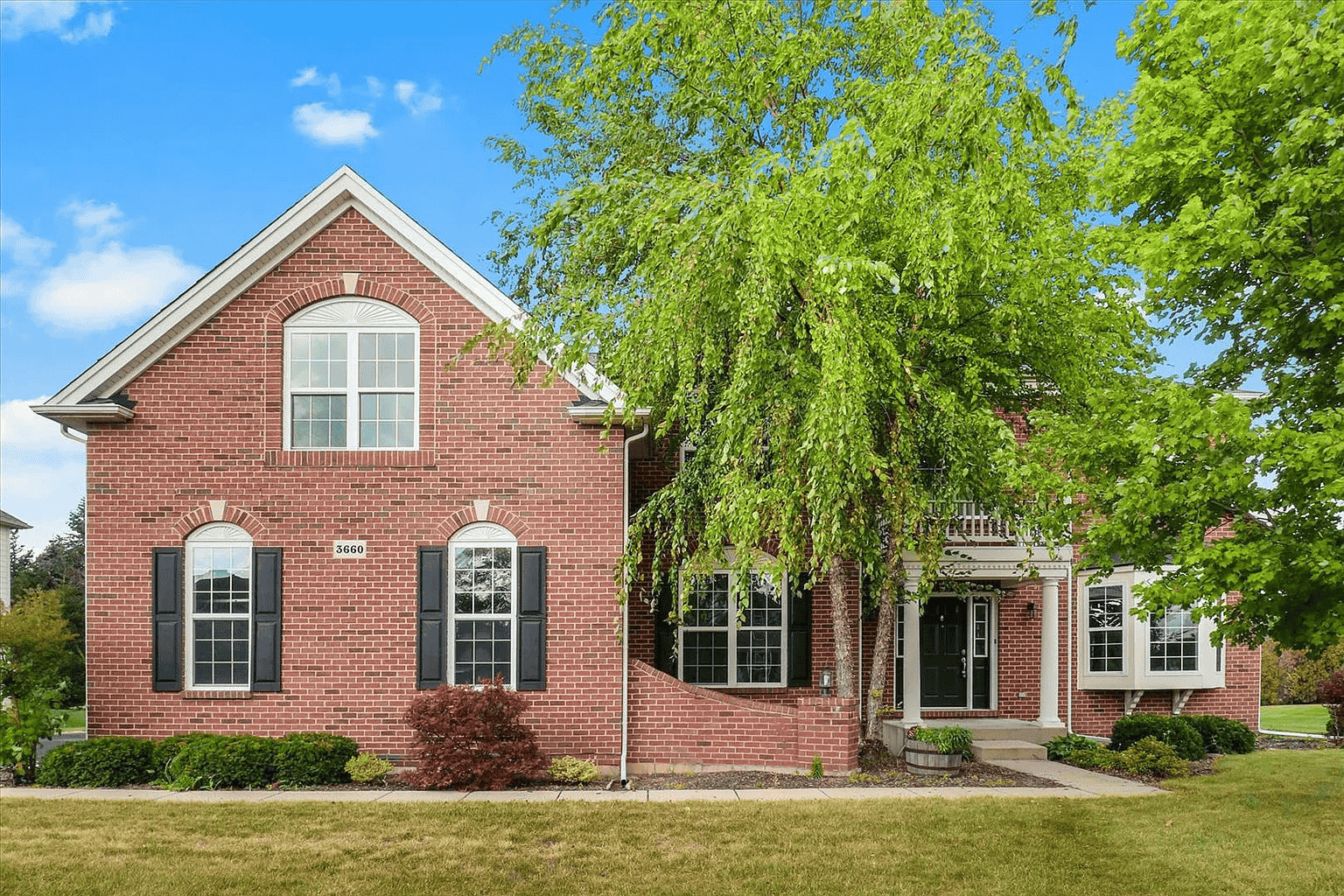 front view of a house with a yard