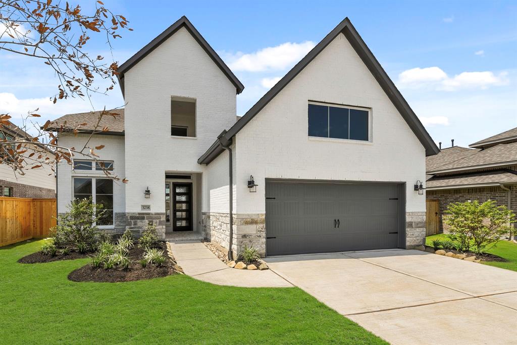 a front view of a house with a yard and garage