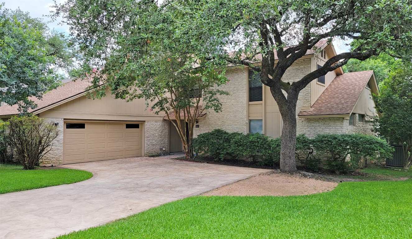 a front view of house with yard and trees