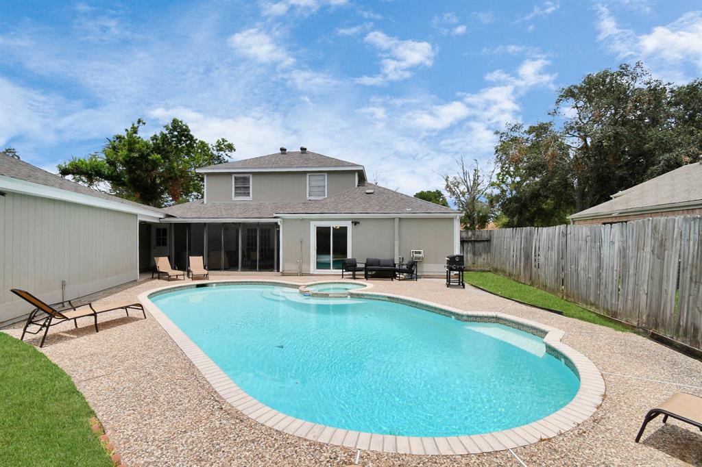 a view of a house with swimming pool and sitting area