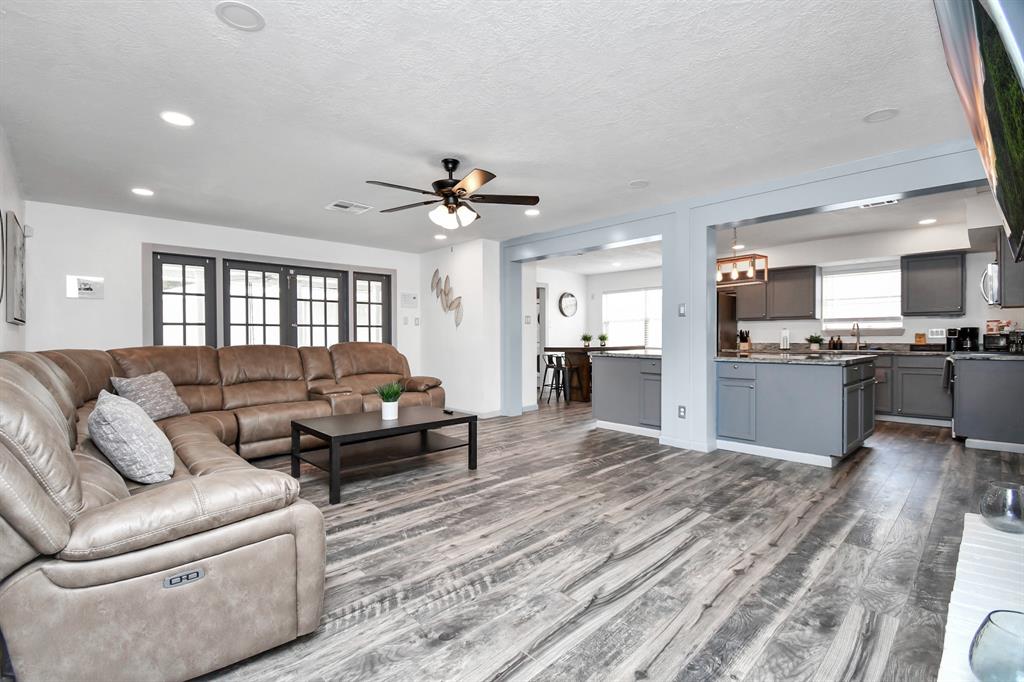 a living room with furniture and kitchen view