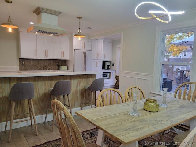 a kitchen with kitchen island a dining table and chairs