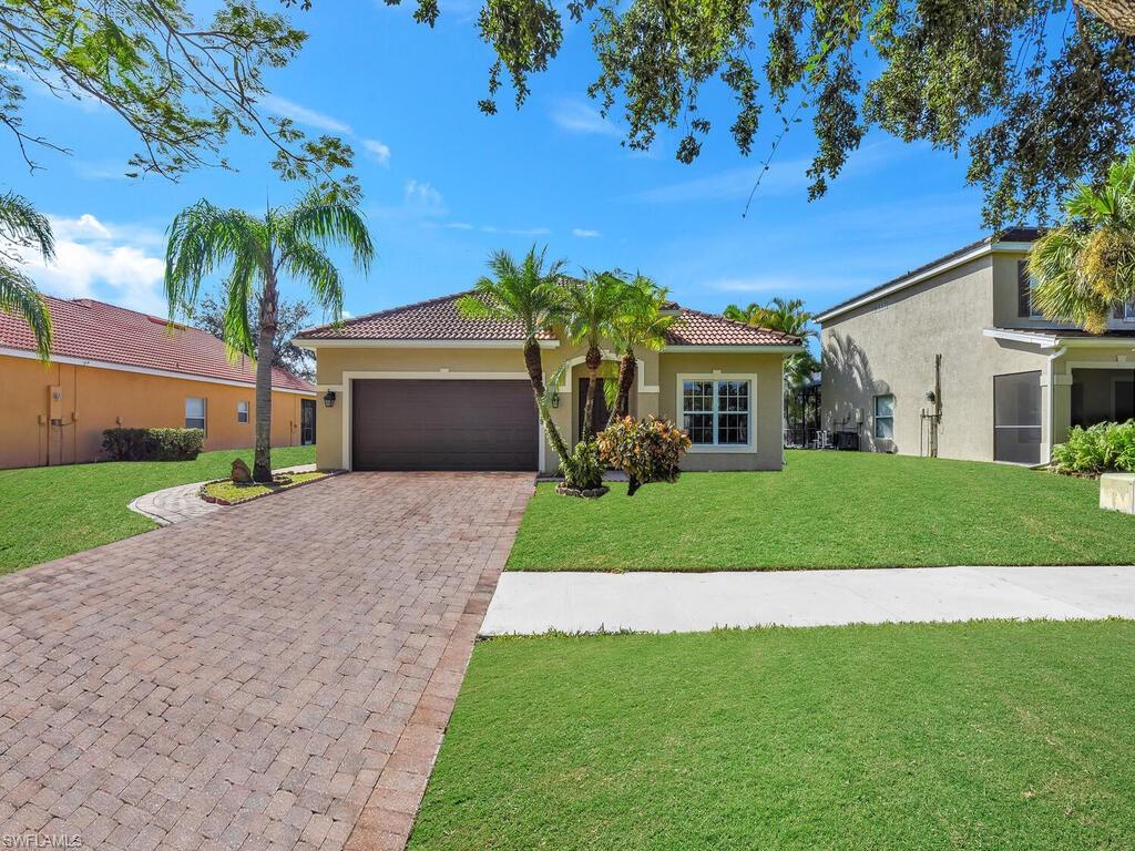 View of front of property with a front lawn and a garage