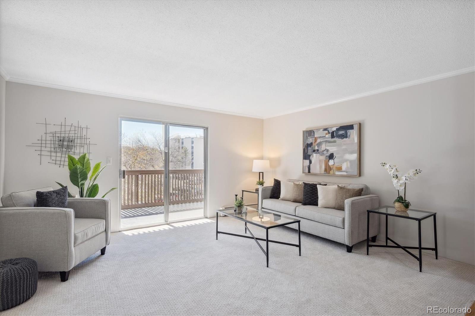 a living room with furniture and a potted plant on table