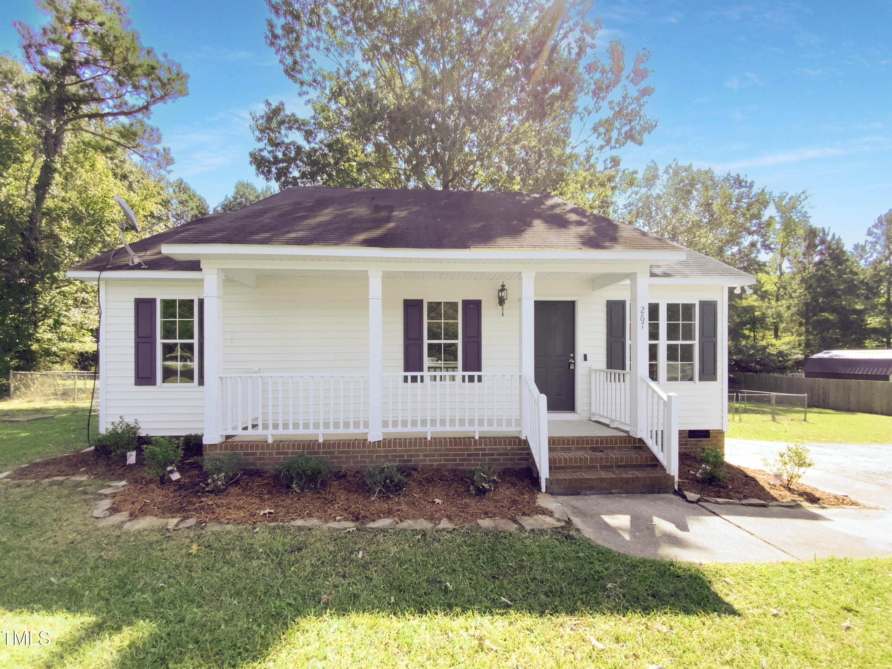 a view of house with a yard